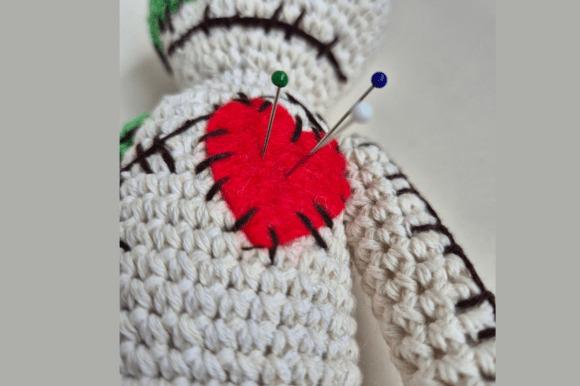 Amigurumi Voodoo Dolls — Crochet Halloween Patterns Amigurumi voodoo doll with stitched heart and pins — Crochet Halloween Patterns
