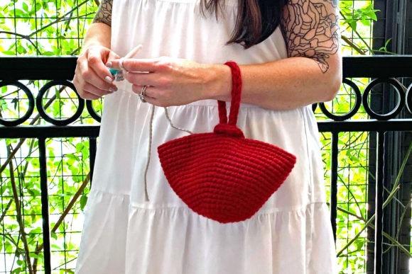 Red Crochet Clutch Bag — Crochet clutch bag patterns Red crochet clutch bag with wrist loop held by person wearing white dress — Crochet clutch bag patterns