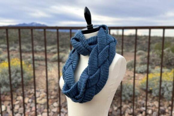 Braided Infinity Scarf — Crochet Scarf Patterns Braided Infinity Scarf Crochet Pattern in blue on a mannequin — Crochet Scarf Patterns