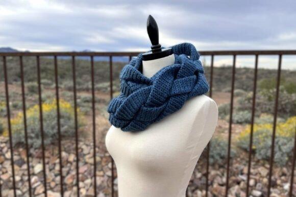 Braided Infinity Scarf — Crochet Scarf Patterns Braided Infinity Scarf Crochet Pattern in blue yarn on a mannequin — Crochet Scarf Patterns