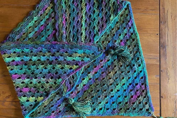 Cascading Shawl Pattern — crochet shawl patterns Crochet shawl in vibrant colors showcasing intricate patterns. — crochet shawl patterns