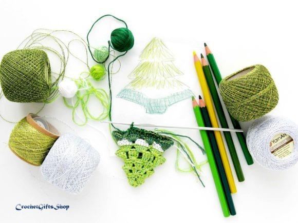 Crochet Christmas Ornaments Patterns Crochet Christmas Ornaments Patterns with green and white yarn, crochet hook, colored pencils, and a tree sketch