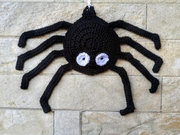 Crochet Halloween Spider — Crochet Halloween Patterns Crochet Halloween spider with white eyes on a stone wall — Crochet Halloween Patterns