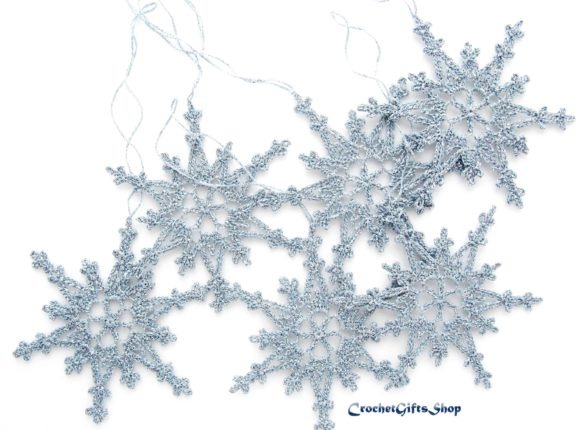 Crochet Snowflake Ornaments — Crochet Christmas Ornaments Patterns Crochet Christmas snowflakes in silver thread, showcasing intricate lace designs. — Crochet Christmas Ornaments Patterns