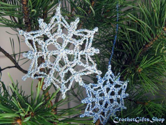 Crochet Snowflake Ornaments — Crochet Christmas Ornaments Patterns Crochet Christmas snowflake ornaments in blue and silver hanging on a pine tree. — Crochet Christmas Ornaments Patterns