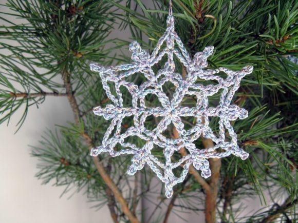 Crochet Snowflake Ornament — Crochet Christmas Ornaments Patterns Crochet Christmas snowflake ornament hanging on a pine tree branch. — Crochet Christmas Ornaments Patterns