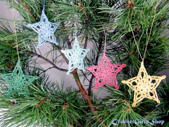 Crochet Christmas Star Ornaments — Crochet Christmas Ornaments Patterns Crochet Christmas ornaments in star shapes hanging on a pine tree. — Crochet Christmas Ornaments Patterns