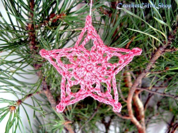 Crochet Christmas Star Ornament — Crochet Christmas Ornaments Patterns Crochet Christmas star ornament in pink hanging on a pine branch. — Crochet Christmas Ornaments Patterns