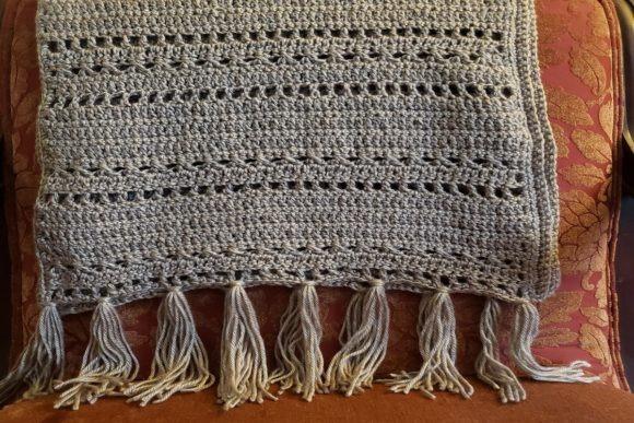 Crochet Pockets Shawl — crochet shawl patterns Crochet Pockets Shawl showcasing tassel detail and rectangular design. — crochet shawl patterns