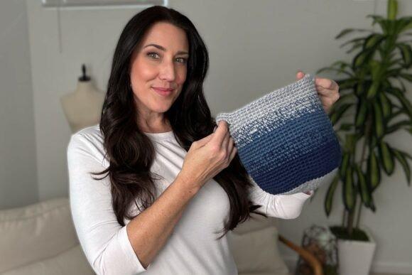 Cutie Utility Basket Crochet Pattern — crochet basket patterns Crochet basket in three colors held by a woman — crochet basket patterns
