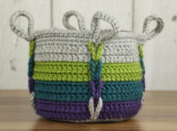 Entwined Basket Crochet Pattern — crochet basket patterns Crochet basket with integrated handles and braided detail in multiple colors. — crochet basket patterns