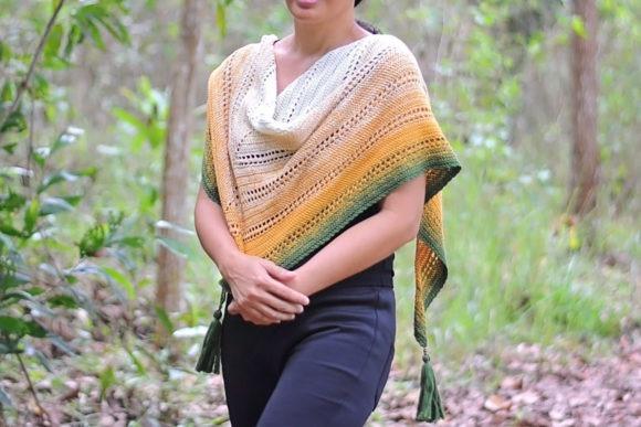Genara Shawl — crochet shawl patterns Crochet shawl in shades of yellow, green, and white worn by a woman outdoors. — crochet shawl patterns