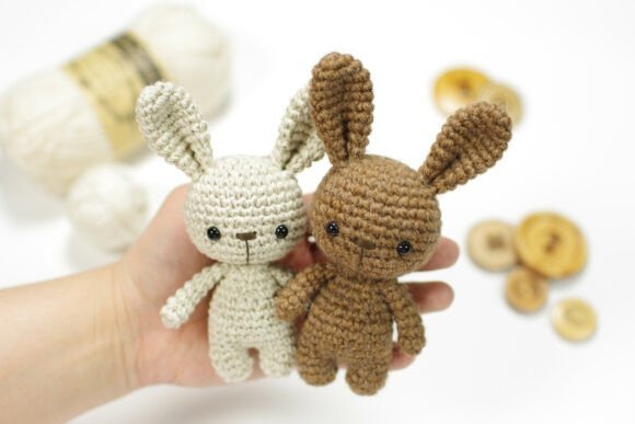 Mini Bunny Amigurumi Patterns — amigurumi crochet patterns Two mini bunny amigurumi figures in hand, showcasing different yarn colors. — amigurumi crochet patterns