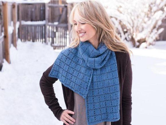 Square Squared Crochet Scarf — Crochet Scarf Patterns Woman wearing a blue crochet scarf with repeating square motifs in a snowy outdoor setting — Crochet Scarf Patterns
