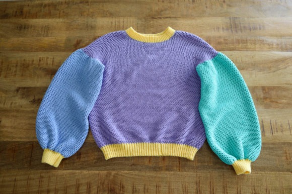 Cozy Crochet Sweater — crochet sweater patterns Crochet sweater with balloon sleeves in purple, blue, and yellow. — crochet sweater patterns