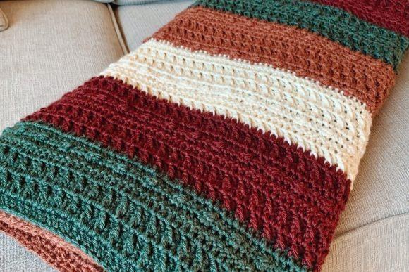 Jaske Throw Blanket — cozy crochet blanket patterns Cozy crochet blanket patterns featuring textured stripes in earthy tones.