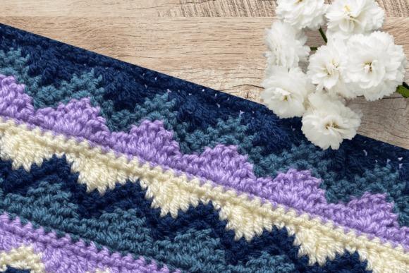 Winter Solstice Crochet Blanket — cozy crochet blanket patterns Cozy crochet blanket patterns featuring a colorful design in DK yarn.