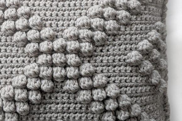 XO Bobble Pillow Cover — crochet pillow patterns Crochet pillow featuring bobble stitches in a textured design. — crochet pillow patterns