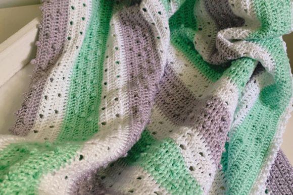 Pretty Picot Baby Blanket — Crochet Baby Blanket Patterns Crochet Baby Blanket Patterns featuring a textured design in green and purple stripes.