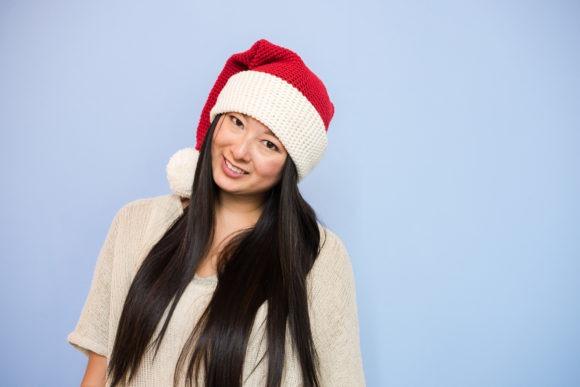 Santa Hat Crochet Pattern — Christmas Crochet Patterns Santa hat crochet pattern worn by a person — Christmas Crochet Patterns