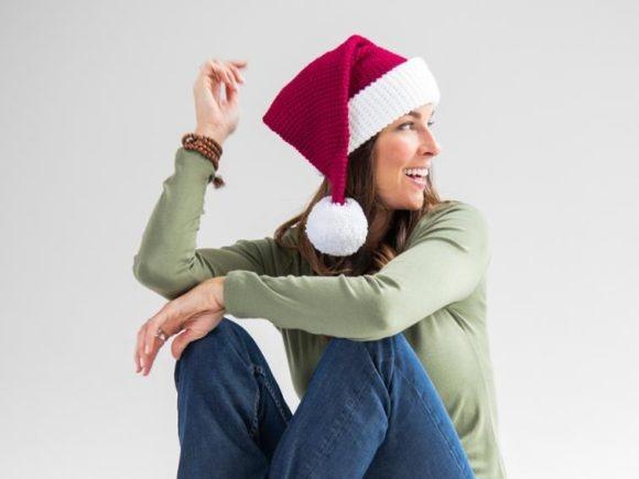 Santa Hat Crochet Pattern — Christmas Crochet Patterns Santa hat crochet pattern worn by a woman — Christmas Crochet Patterns