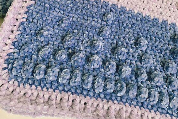 Velvety Dreams Baby Blanket — Crochet Baby Blanket Patterns Crochet Baby Blanket Patterns featuring a velvety texture in blue and purple hues.