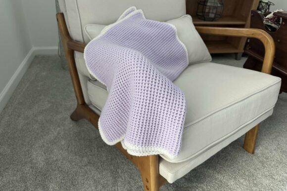 Waffle Weave Crochet Baby Blanket — Crochet Baby Blanket Patterns Waffle Weave Crochet Baby Blanket in light purple on a chair — Crochet Baby Blanket Patterns