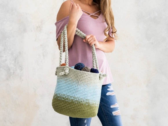 Cutie Utility Bucket Bag — crochet bag patterns Cutie Utility Bucket Bag crochet pattern in blue and green, held by a woman. — crochet bag patterns