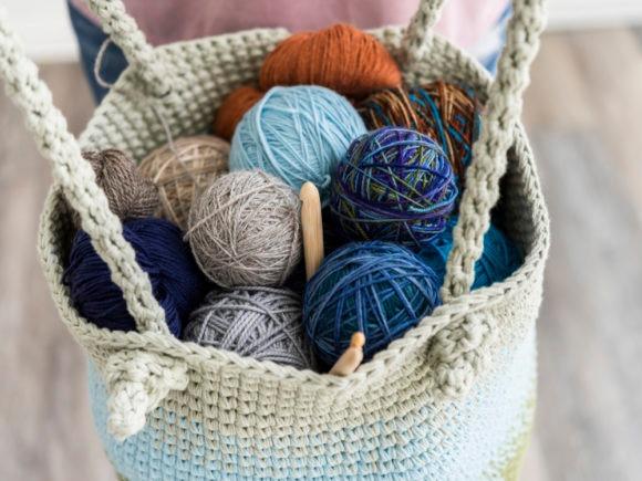 Crochet Bag with Yarn — crochet bag patterns Crochet bag filled with colorful yarn balls and a crochet hook. — crochet bag patterns