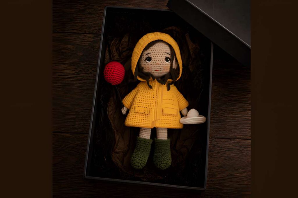 Autumn Amigurumi Doll in a raincoat, showcasing amigurumi crochet patterns.
