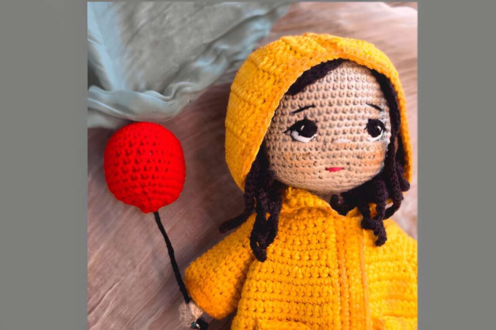 Autumn Amigurumi Doll Pattern featuring a doll in a yellow raincoat holding a red balloon. — amigurumi crochet patterns