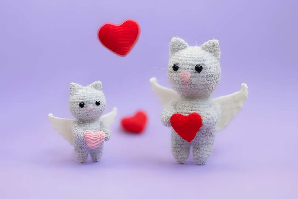 Amigurumi crochet patterns featuring cute cat characters with hearts.