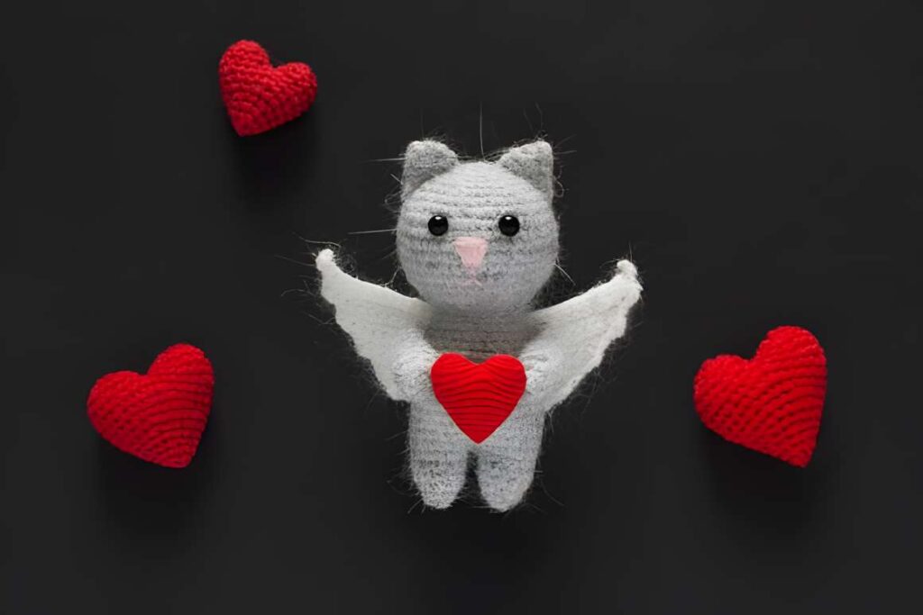 Amigurumi crochet patterns featuring a cat character with hearts.