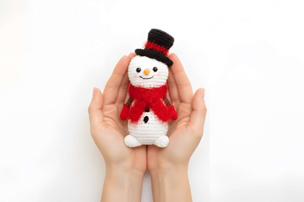 Amigurumi crochet patterns featuring a snowman toy, perfect for winter events.