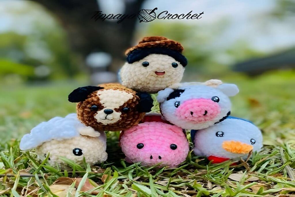Amigurumi crochet patterns featuring farm animals including a pig, sheep, duck, dog, farmer, and cow.