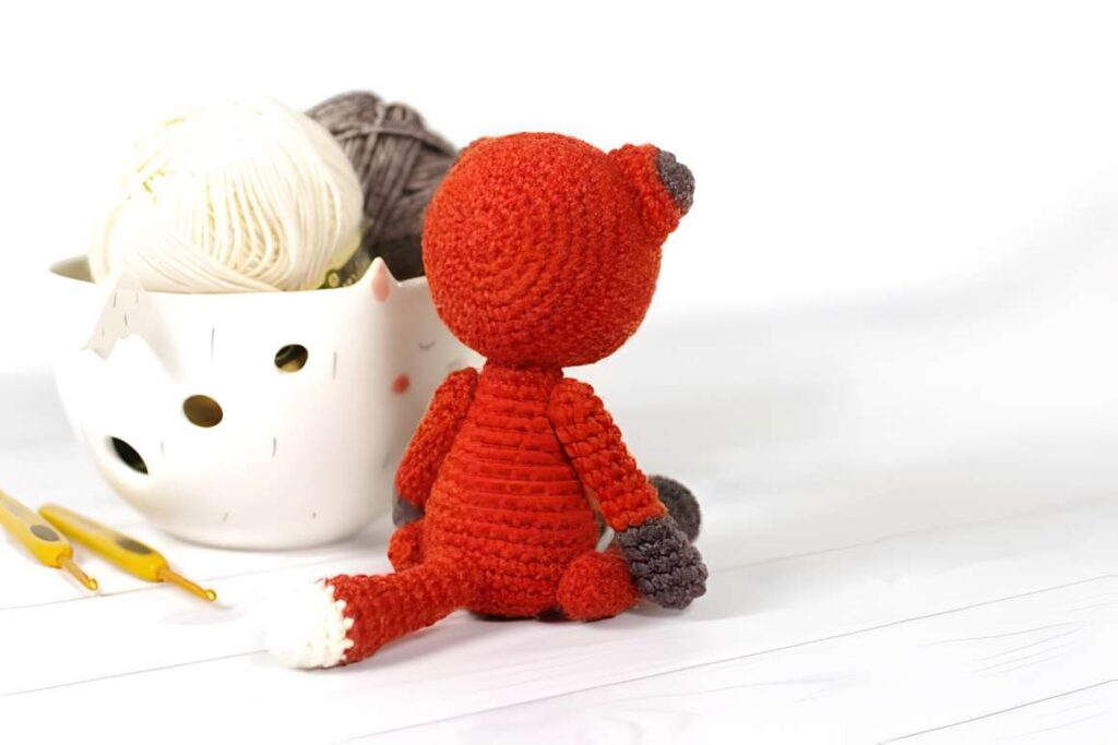 Amigurumi crochet patterns featuring a small fox with yarn.