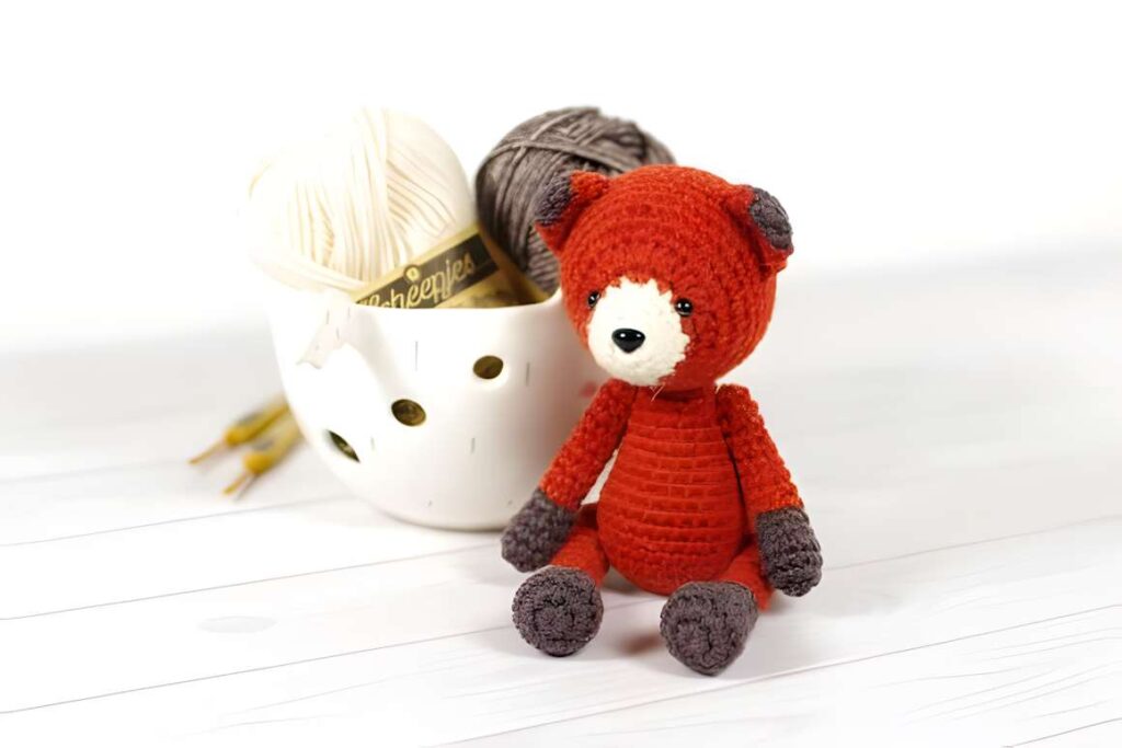 Amigurumi crochet patterns featuring a small fox toy with yarn.