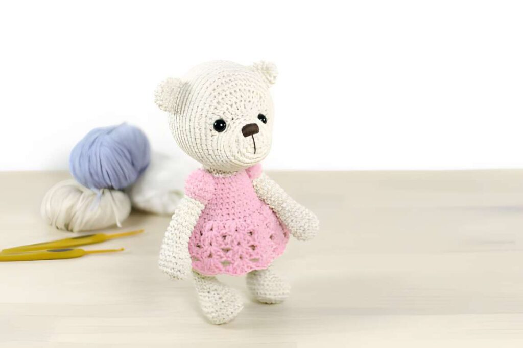 Amigurumi crochet patterns featuring a teddy bear in a pink dress.