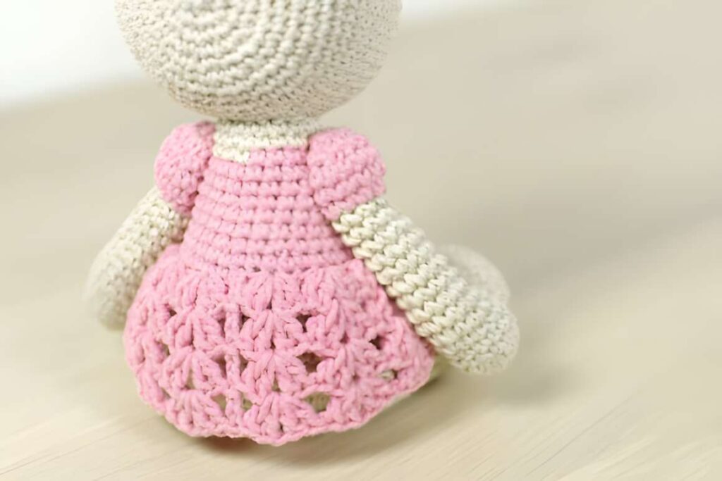 Amigurumi crochet patterns featuring a teddy girl with a pink dress.